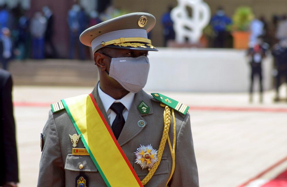 Col. Assimi Goita, leader of two military coups and new interim president, walks during his inauguration ceremony in Bamako, Mali, on June 7, 2021. (Amadou Keita/Reuters)