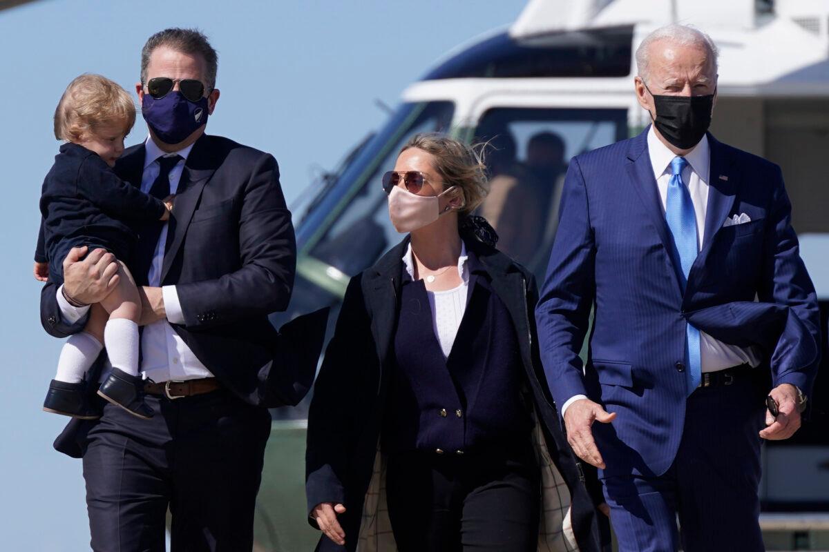 President Joe Biden walks with his son Hunter Biden, second from left, as Hunter carries his son Beau and walks next to his wife Melissa Cohen, center, before boarding Air Force One at Andrews Air Force Base, Md., on March 26, 2021. (Patrick Semansky/AP Photo)