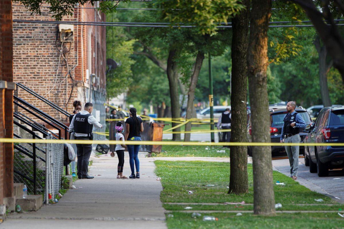Police investigate the scene of a shooting near 1324 S Christiana Ave in Chicago's Lawndale neighborhood on July 21, 2021. (Anthony Vazquez/Chicago Sun-Times via AP)
