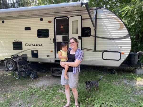 Danielle Londrigan and her daughter, Kyla, 2, stand in front of the RV the Londrigan family is moving into for at least one year. (Tamara Browning)
