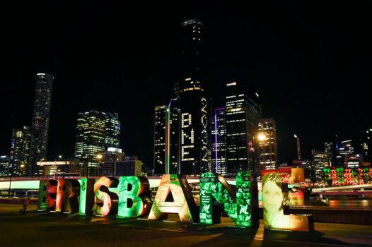 A general view is seen as "BNE 2032" is displayed on a building during the announcement of the host city for the 2032 Olympic Games, watched via live feed in Tokyo, at the Brisbane Olympic Live Site in Brisbane, Australia, on July 21, 2021. (Albert Perez/Getty Images)