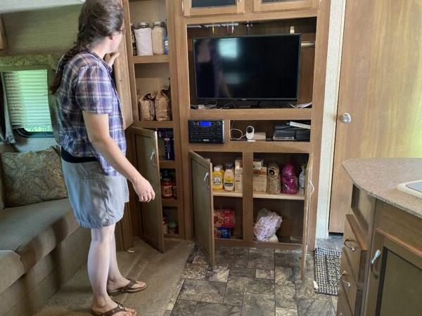 Danielle Londrigan shows us her “pantry” in the RV that the Londrigan family is moving into for at least one year. (Tamara Browning)