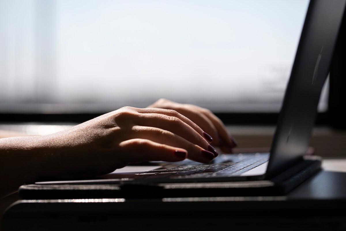 A woman typing on a laptop. (AP Photo/Jenny Kane)