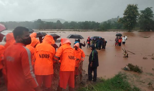 India's National Disaster Response Force (NDRF) personnel rescuing people stranded in floodwaters in Chiplun, in the western Indian state of Maharashtra, India, on July 23, 2021. (National Disaster Response Force via AP)