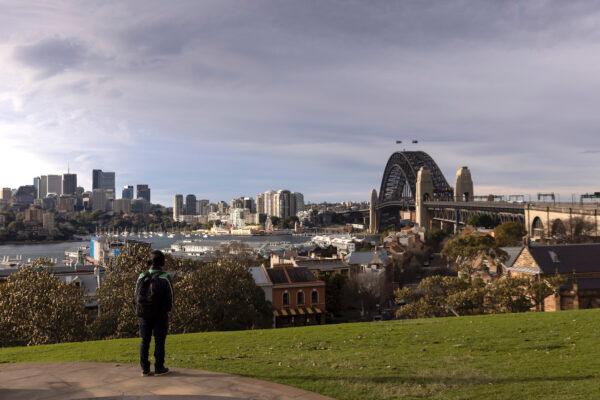 A person looks out over the Harbour Bridge from Observatory Hill in Sydney, Australia, on July 20, 2021. (Brook Mitchell/Getty Images)