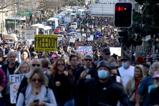 Protesters march along Broadway and George St towards Sydney Town Hall during the ‘World Wide Rally For Freedom’ anti-lockdown rally at Hyde Park in Sydney on July 24, 2021. (AAP Image/Mick Tsikas)