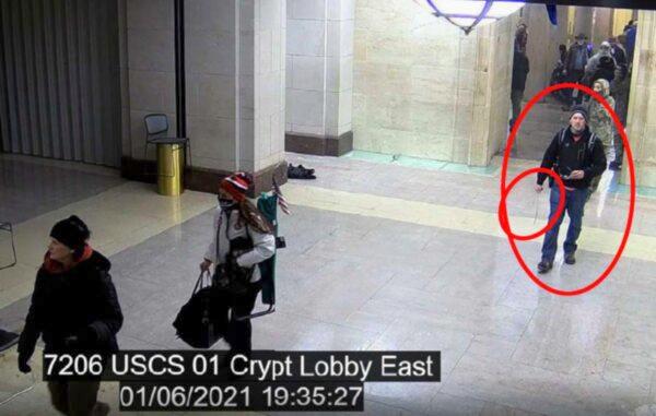 (Circled) Andrew Taake, 32, is seen walking while holding a "whip-like weapon" through the U.S. Capitol building in Washington on Jan. 6, 2021. (Courtesy of the FBI)
