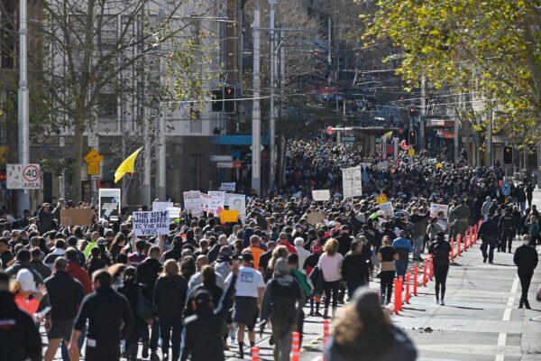 Thousands of protesters march on the streets of the central business district of Sydney on July 24, 2021. (Steven Saphore/AFP via Getty Images)