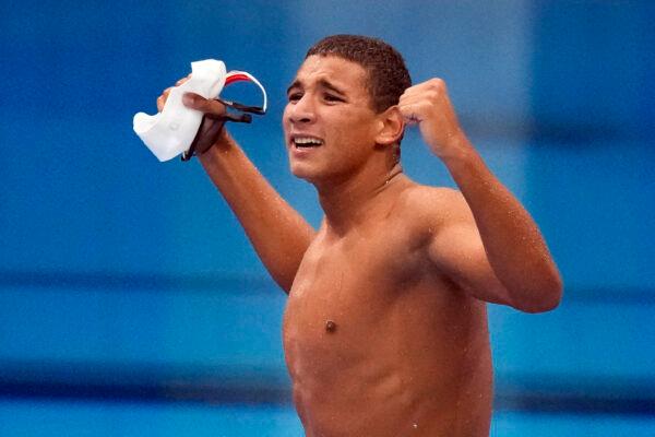 Ahmed Hafnaoui, of Tunisia, celebrates after winning the final of the men's 400-meter freestyle at the 2020 Summer Olympics in Tokyo, Japan, on July 25, 2021. (Charlie Riedel/AP)