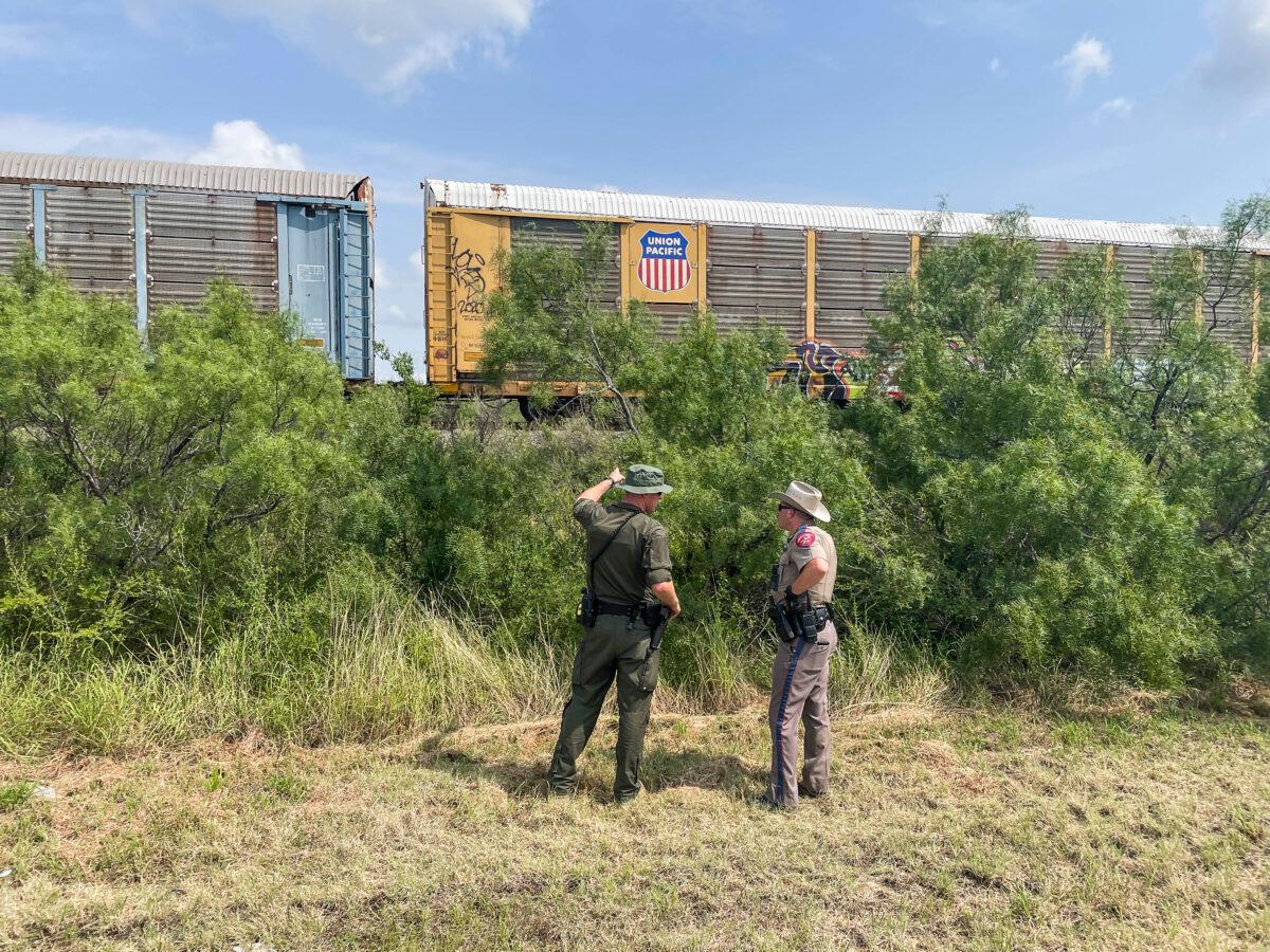 Texas and Nebraska State Troopers look for illegal immigrants hiding on a freight train heading to San Antonio in Kinney County, Texas, on July 21, 2021. (Charlotte Cuthbertson/The Epoch Times)