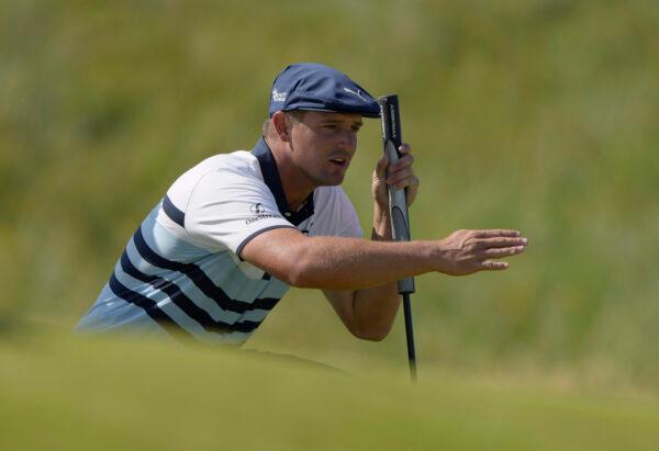 United States' Bryson DeChambeau gestures as he lines up his putt on the 2nd green during the third round of the British Open Golf Championship at Royal St George's golf course in Sandwich, England, on July 17, 2021. (Alastair Grant/AP)