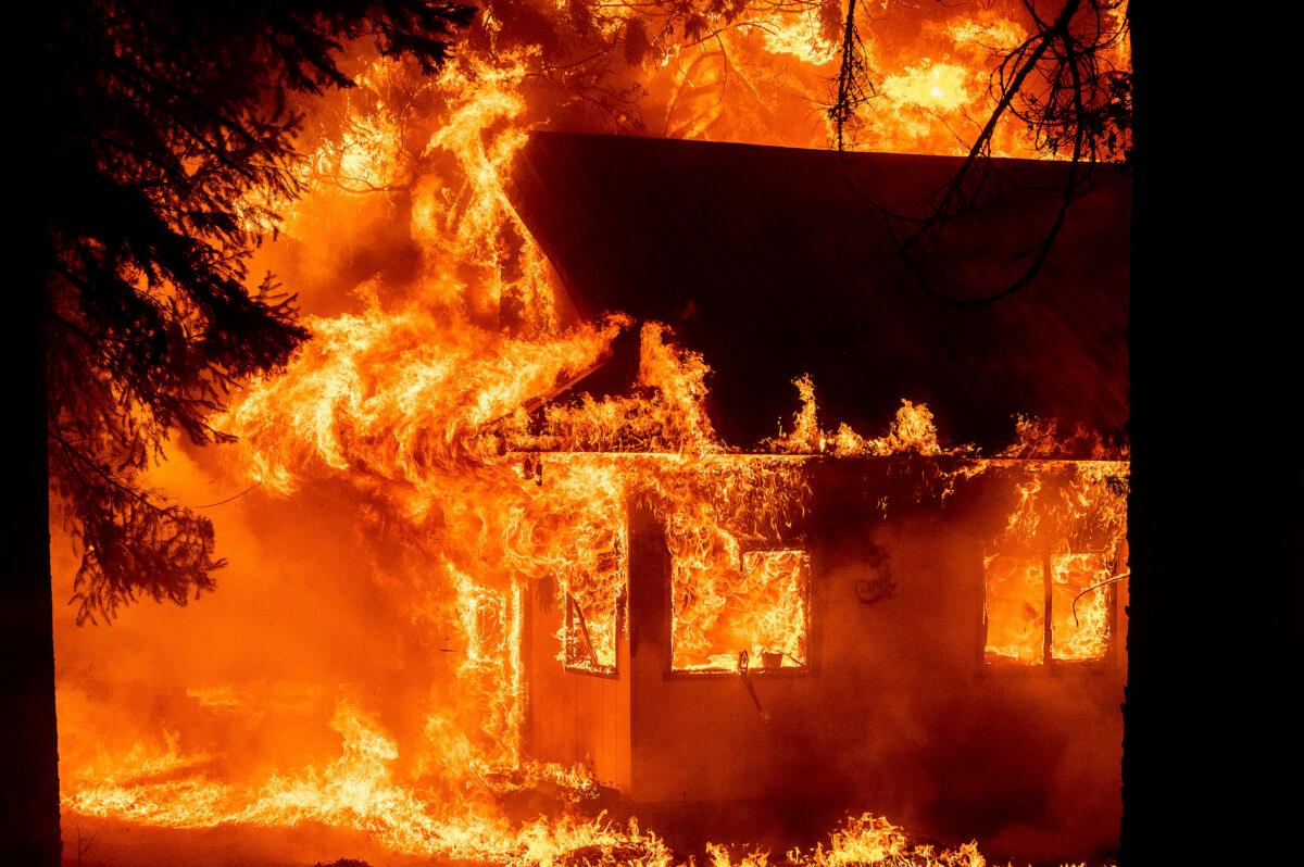 Flames consume a home as the Dixie Fire tears through the Indian Falls community in Plumas County, Calif., on July 24, 2021. (Noah Berger/AP Photo)