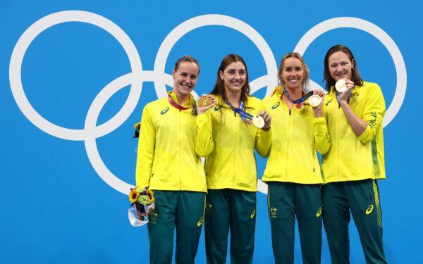 Gold medalists Emma McKeon of Australia, Meg Harris of Australia, Cate Campbell of Australia and Bronte Campbell of Australia celebrate on the podium at the Tokyo 2020 Olympics after winning the Women's 4 x 100m Freestyle Relay on July 25, 2021. (Kai Pfaffenbach/Reuters)