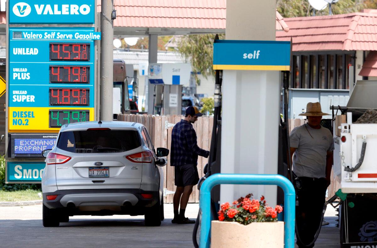 A customer prepares to pump gasoline into his car at a Valero station in Mill Valley, Calif., on July 12, 2021. (Justin Sullivan/Getty Images)