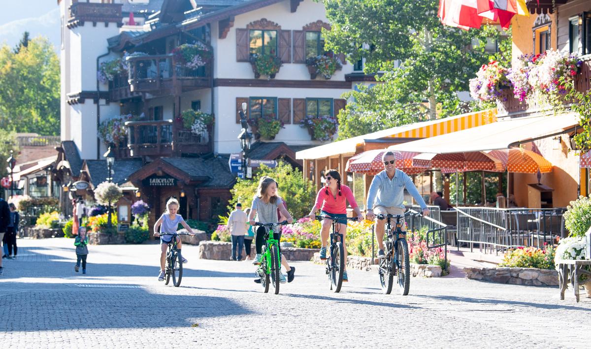 A family bikes through the village in Vail. (Jack Affleck/ Vail Local Marketing District)