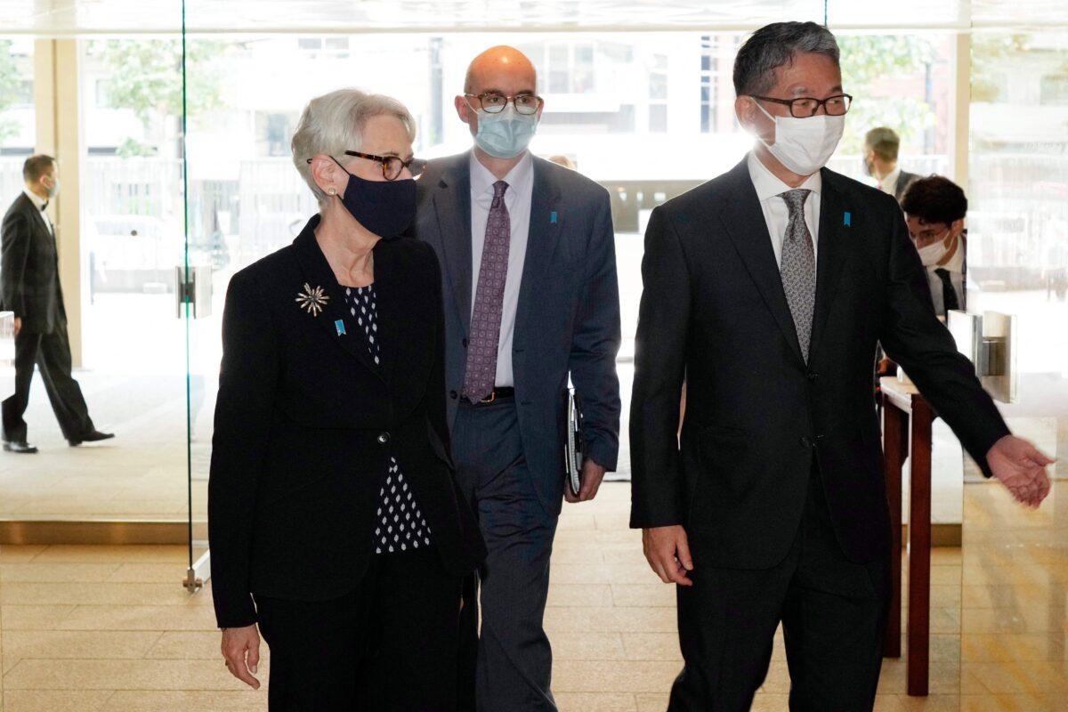 U.S. Deputy Secretary of State Wendy Sherman (L) is escorted by Japan's Vice Minister for Foreign Affairs Takeo Mori (R) prior to their meeting at the Iikura Guesthouse in Tokyo on July 20, 2021. (Eugene Hoshiko/Pool/AFP via Getty Images)