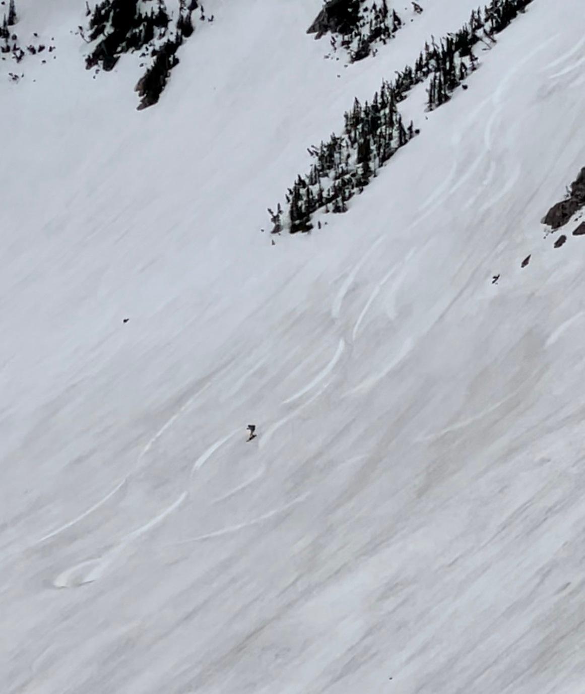 Snowboarder off summit. (Tami Ellis)