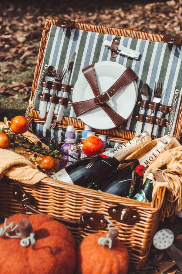 Picnic baskets come in all shapes and sizes, from traditional wicker hampers to insulated totes and backpacks. Find the one that works best for you. (Kin Li/Unsplash)