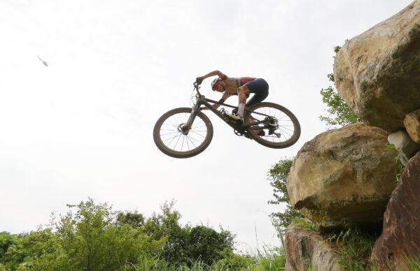 Thomas Pidcock of Team Great Britain jumps off a boulder during the Men's Cross-country race on day three of the Tokyo 2020 Olympic Games at Izu Mountain Bike Course in Izu, Shizuoka, Japan, on July 26, 2021. (Michael Steele/Getty Images)