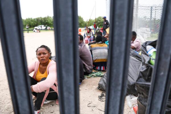 A group of more than 350 illegal immigrants waits for Border Patrol after crossing the Rio Grande from Mexico into Del Rio, Texas, on July 25, 2021. (Charlotte Cuthbertson/The Epoch Times)