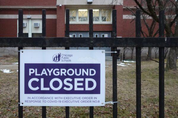 A sign outside of Columbus Elementary School lets visitors know that the playground has been closed in Chicago, Illinois, on Jan. 25, 2021. (Scott Olson/Getty Images)