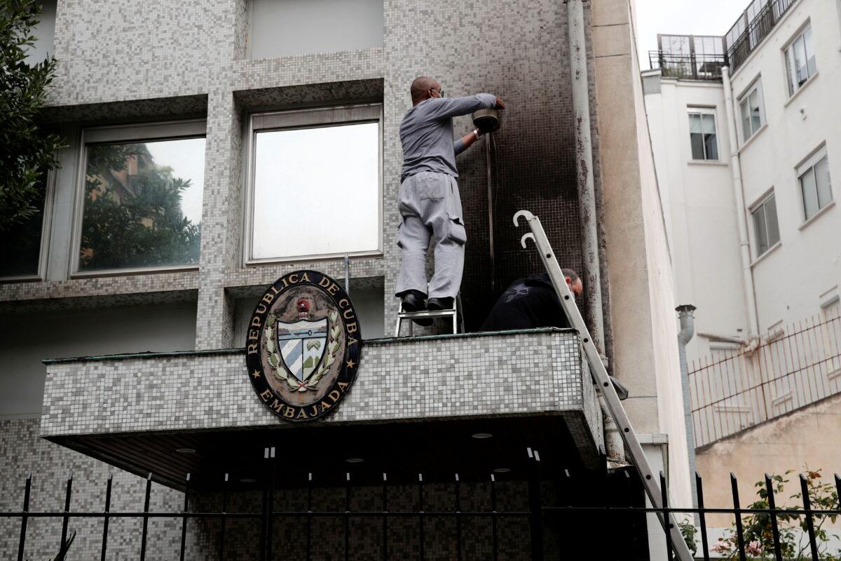 Experts inspect the damage at the Cuban embassy following an overnight petrol bomb attack on its building, in Paris, France, on July 27, 2021. (Benoit Tessier/Reuters)
