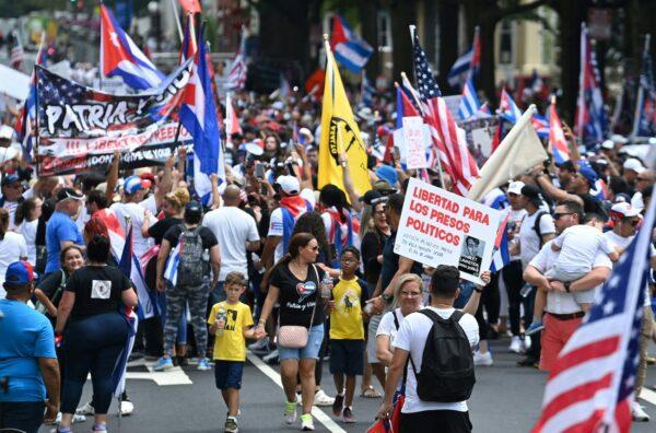 People march during a Cuba protest as people wave signs and Cuban flags near the White House on July 26, 2021. (Brendam Smialowski/AFP via Getty Images)