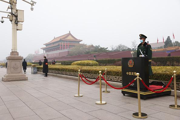 An armed officer wears a face mask as he stands guard in front of Tiananmen Gate before the opening ceremony of the fourth session of the 13th National Committee of the Chinese People's Political Consultative Conference (CPPCC) in Beijing, on March 4, 2021. (Lintao Zhang/Getty Images)