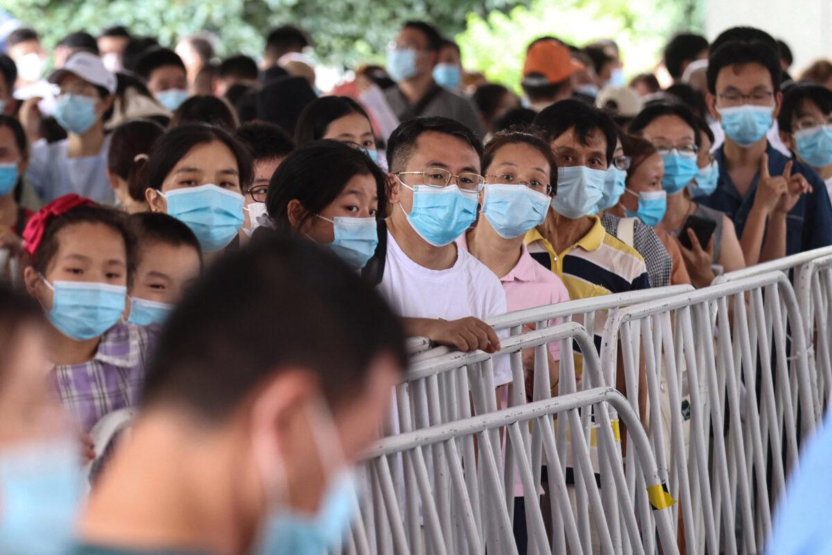 Residents queue to receive nucleic acid tests for the COVID-19 in Nanjing, in eastern China's Jiangsu Province on July 21, 2021. (STR/AFP via Getty Images)