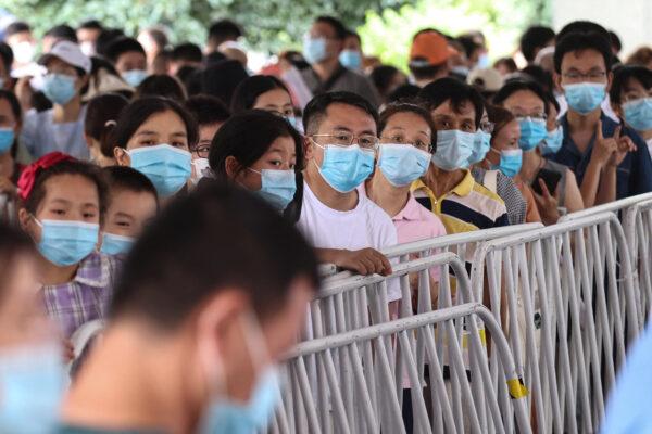 Residents queue to receive nucleic acid tests for the COVID-19 in Nanjing, in eastern Jiangsu province, China, on July 21, 2021. (STR/AFP via Getty Images)