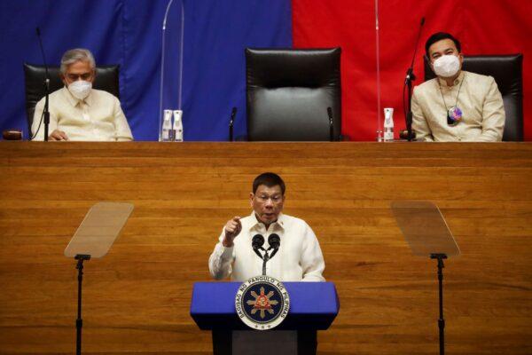 Philippine President Rodrigo Duterte delivers his 6th State of the Nation Address (SONA) as Senate President Vicente Sotto III and House Speaker Lord Allan Velasco listen, at the House of Representative in Quezon City, Metro Manila, Philippines, on July 26, 2021. (Lisa Marie David/Reuters)