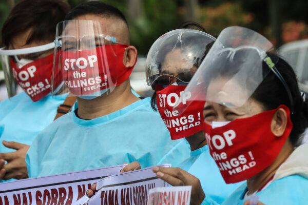 Protesters wear face masks with slogans before marching towards the House of Representative where Philippine President Rodrigo Duterte is set to deliver his final State of the Nation Address in Quezon city, Philippines, on July 26, 2021. (Gerard Carreon/AP Photo)
