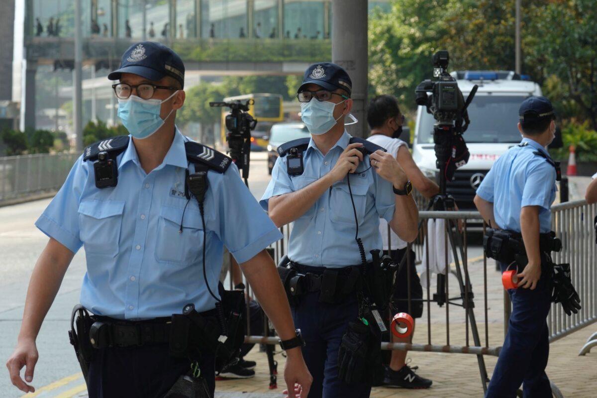 Police officers stand guard as they wait for Tong Ying-kit's arrival at a court in Hong Kong on July 27, 2021. (Vincent Yu/AP Photo)