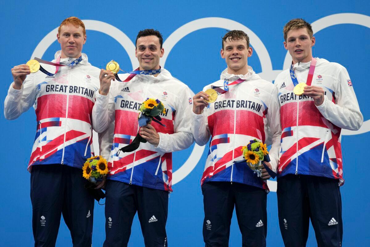 Britain's men's 4x200-meters relay team from left, Tom Dean, James Guy, Matthew Richards, and Duncan Scott pose with their gold medals at the 2020 Summer Olympics, in Tokyo, Japan, on Wednesday, July 28, 2021. (Matthias Schrader/AP Photo)