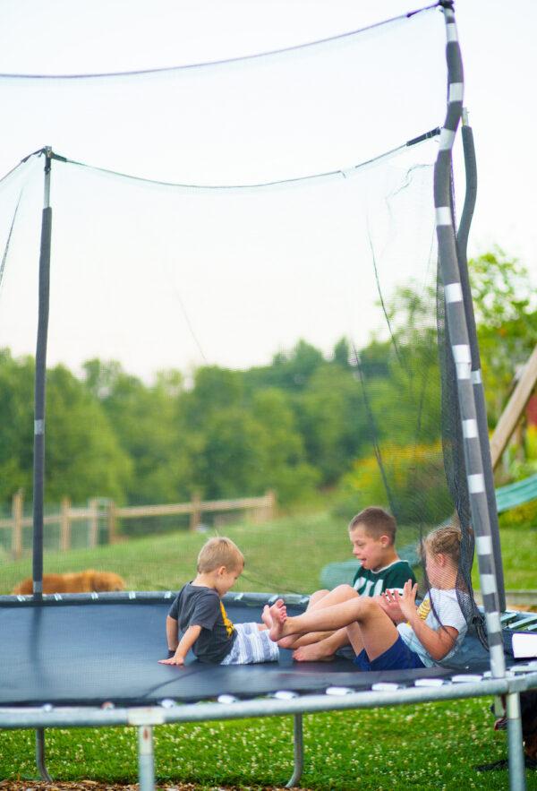 The Miller children enjoy a moment together on a trampoline. (Landon Troyer/Plain Values)