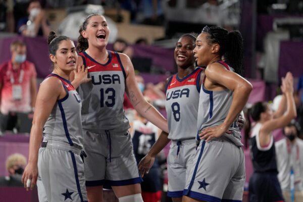 United States' Kelsey Plum (L), Stefanie Dolson (13), Jacquelyn Young (8), and Allisha Gray celebrate after defeating the Russian Olympic Committee in a women's 3-on-3 gold medal basketball game at the 2020 Summer Olympics, in Tokyo, Japan, on July 28, 2021. (Jeff Roberson/AP Photo)