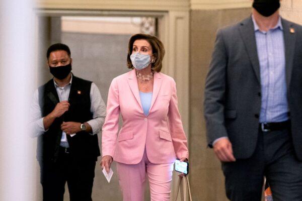 House Speaker Nancy Pelosi (D-Calif.) (center) wears a protective mask while departing the U.S. Capitol in Washington on July 25, 2021. (Stefani Reynolds/Getty Images)