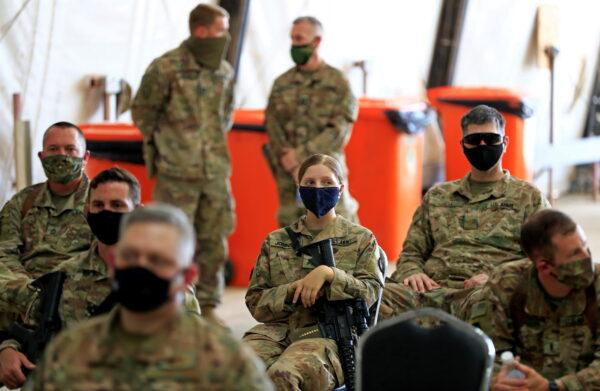 U.S. soldiers wearing protective masks during a handover ceremony of Taji military base from U.S.-led coalition troops to Iraqi security forces, in the base north of Baghdad, Iraq, on Aug. 23, 2020. (Thaier Al-Sudani/Reuters)