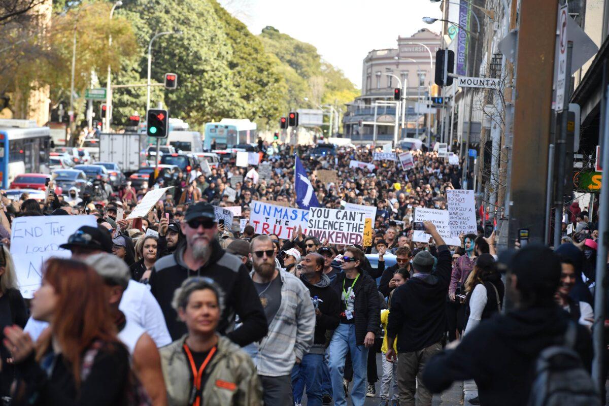 Protesters march along Broadway and George Street toward Sydney Town Hall during the ‘World Wide Rally For Freedom’ anti-lockdown rally at Hyde Park in Sydney, Australia, on July 24, 2021. (AAP Image/Mick Tsikas)