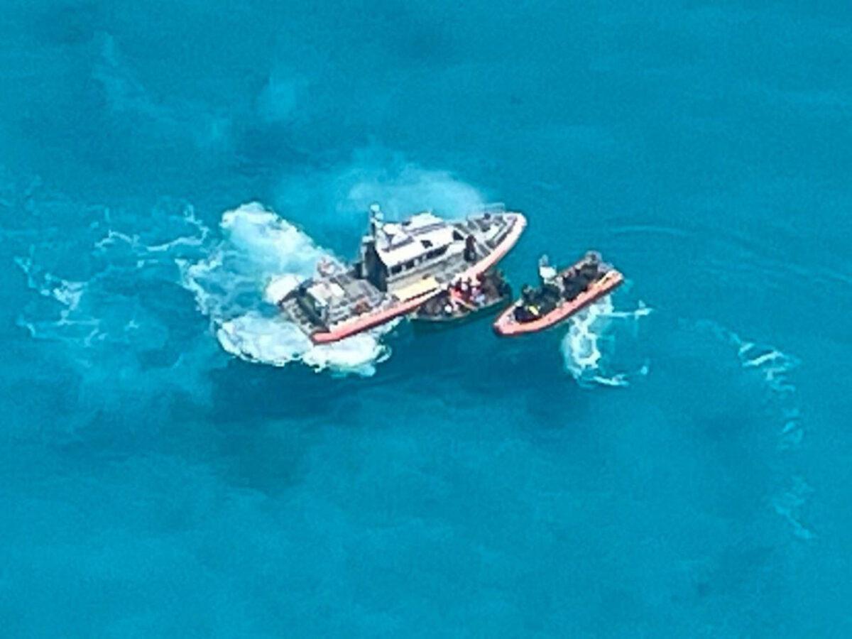 A Coast Guard Station Key West boat crew on scene with a 21-foot vessel with 22 people aboard approximately 7 miles south of Key West, Fla., on July 23, 2021. (U.S. Coast Guard Auxiliary)