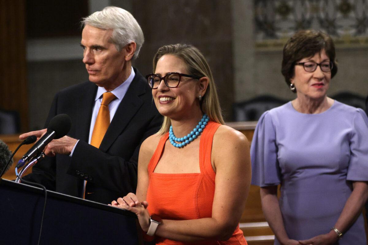 Sen. Rob Portman (R-Ohio) (L) and Sen. Kyrsten Sinema (D-Ariz.) (C) answer questions from members of the press as Sen. Susan Collins (R-Maine) looks on during a news conference on Capitol Hill in Washington, on July 28, 2021. (Alex Wong/Getty Images)