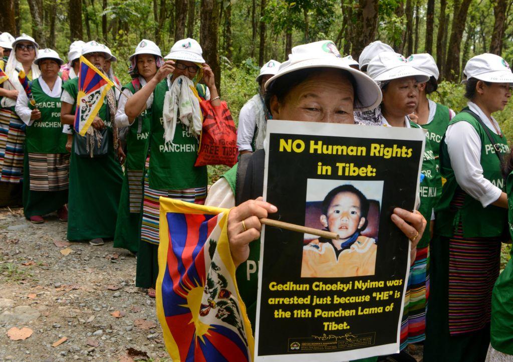 Tibetan Buddhist members of the Tibetan Women Association hold posters on April 29, 2019, as they take part in a silent march on the occasion of the 30th birthday celebration of the 11th Panchen Lama - who disappeared into Chinese custody in 1995 at the age of 6 after being chosen by The Dalai Lama. He has not been seen since then. (Dipendu Dutta/AFP via Getty Images)