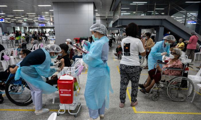Health workers administer the AstraZeneca COVID-19 vaccines to the elderly at Central Vaccination Center in Bang Sue Grand Station in Bangkok, Thailand, on July 13, 2021. (Sirachai Arunrugstichai/Getty Images)