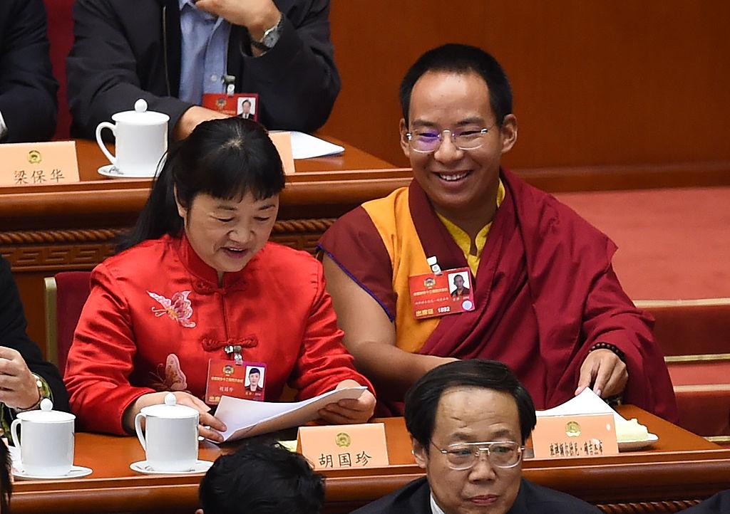 The Chinese regime-selected 11th Panchen Lama Gyaltsen Norbu (C) sits with other delegates during the closing session of the Chinese People's Political Consultative Conference (CPPCC) at the Great Hall of the People in Beijing on March 14, 2016.  (Greg Baker/AFP via Getty Images)