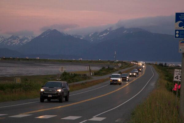 A line of cars evacuating the Homer Spit in Homer, Alaska, after a tsunami warning was issued following a magnitude 8.2 earthquake in the Alaska Peninsula, on July 28, 2021. (Sarah Knapp, Homer News via AP)