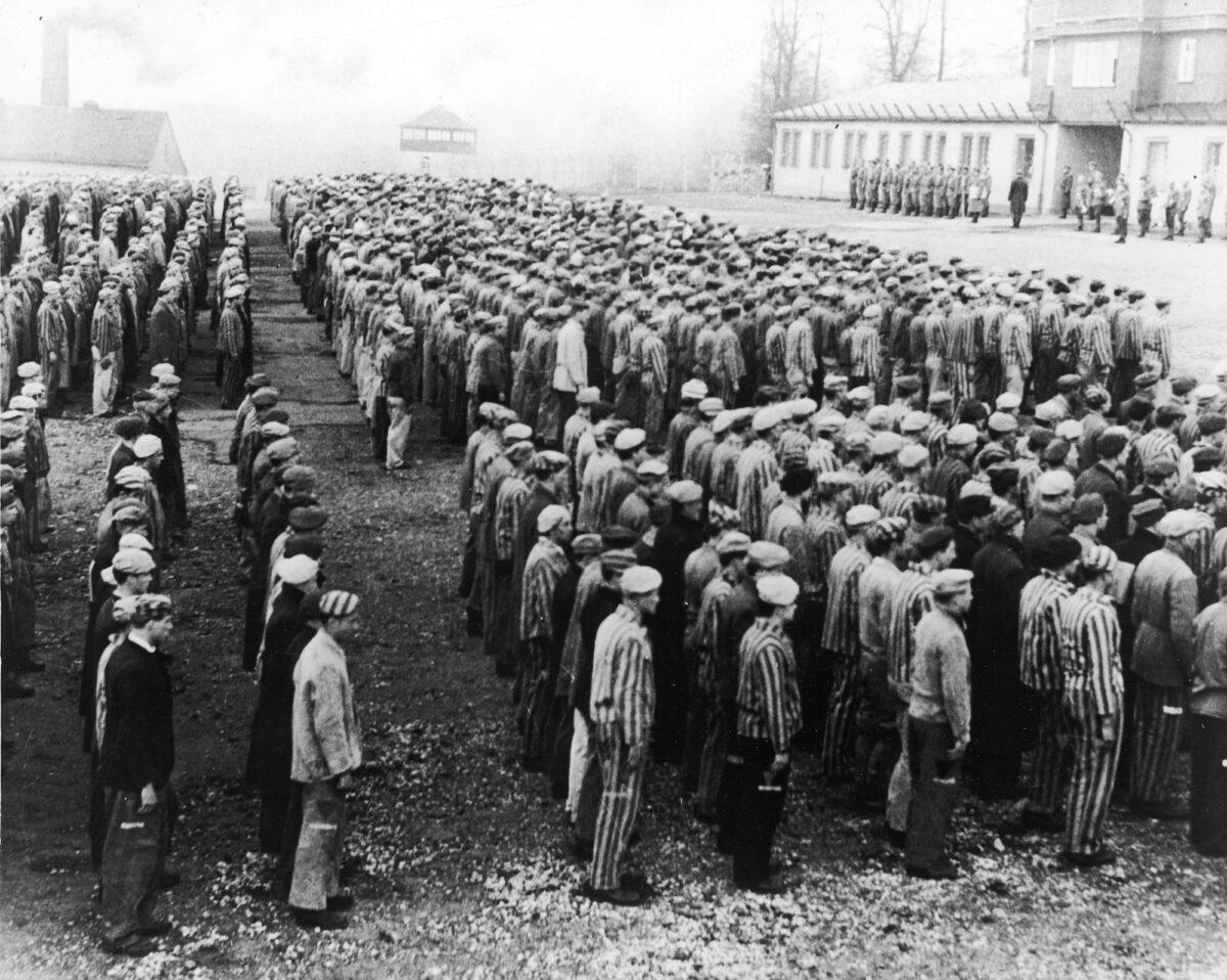 Polish prisoners in striped uniforms stand in rows before Nazi officers at the Buchenwald Concentration Camp in Weimar, Germany, circa 1943. (Frederic Lewis/Getty Images)