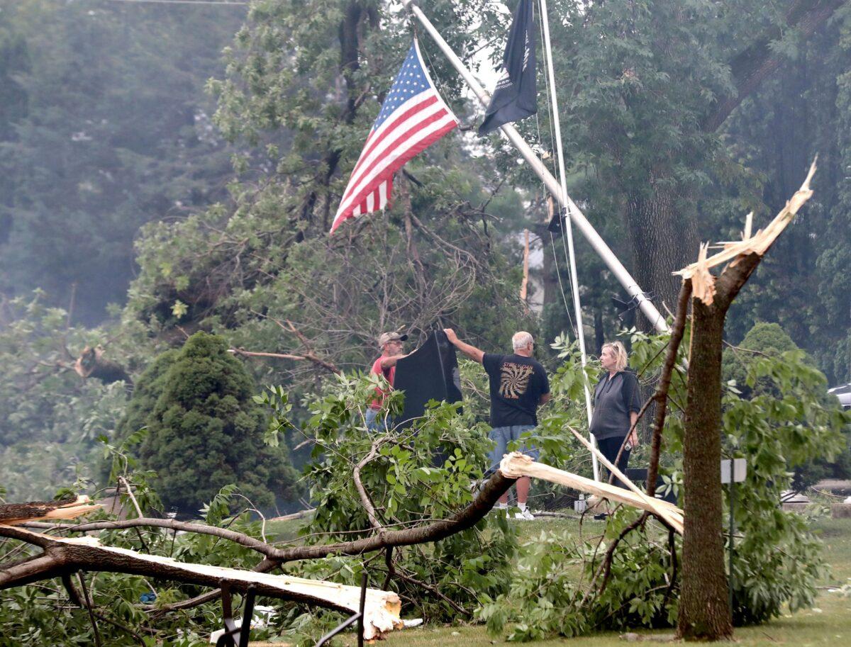 Following an overnight storm, Jefferson County residents inspect damage at Dahnert Park, in Concord, Wis., on July 29, 2021. (John Hart/Wisconsin State Journal via AP)