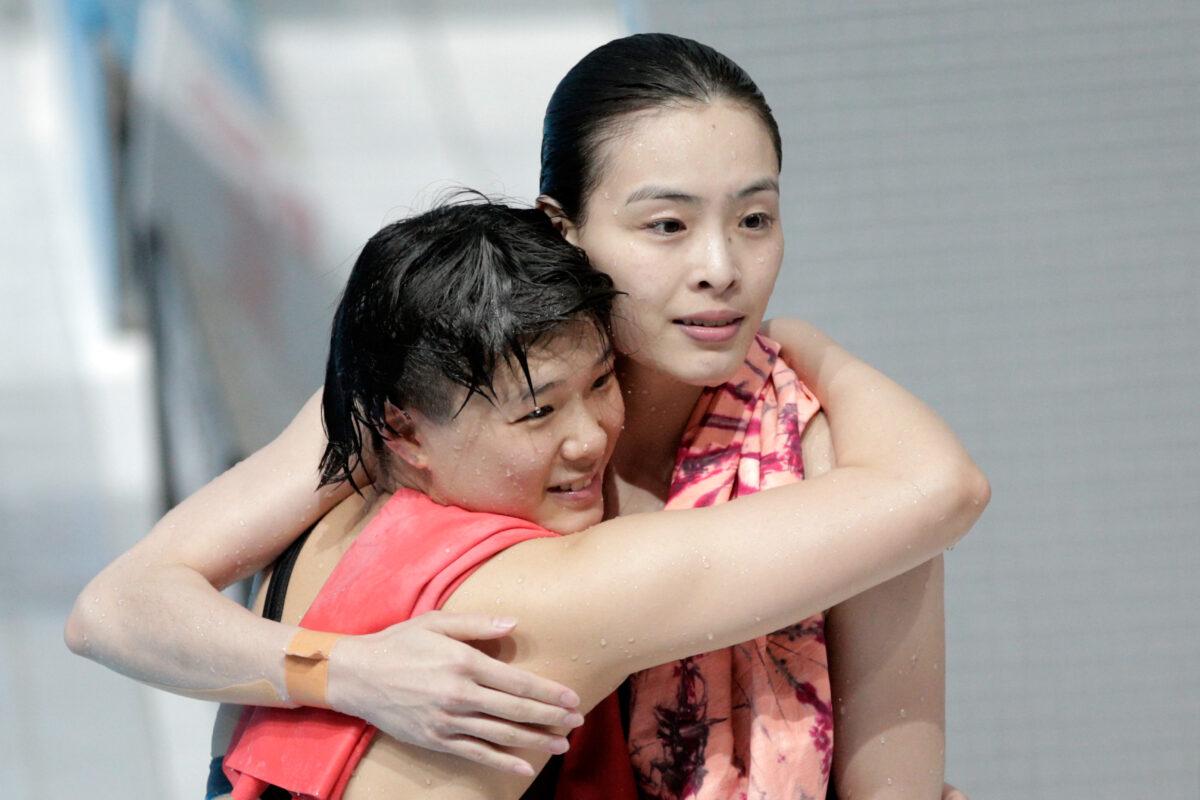 Gold medallists Tingmao Shi (L) and Minxia Wu of China celebrate during the Women's 3m Springboard Synchronised Diving Final on day one of the 16th FINA World Championships at the Aquatics Palace in Kazan, Russia, on July 25, 2015. (Adam Pretty/Getty Images)