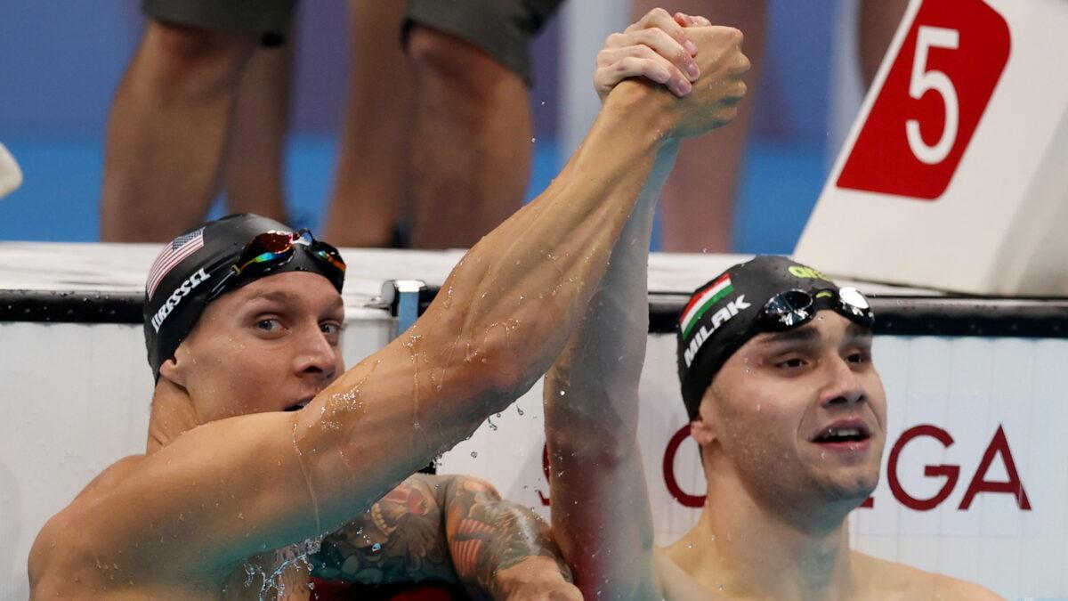 Caeleb Dressel of the United States and Kristof Milak of Hungary react after finishing first and second in the men's 100-meter butterfly at the Tokyo Olympics in Tokyo, Japan, on July 31, 2021. (Carl Recine/Reuters)
