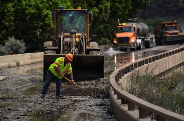 Colorado Department of Transportation crews work to clear mud and debris from the eastbound deck of Interstate 70 through Glenwood Canyon, near Bair Ranch after a flash flood, Colo., on July 22, 2021. (Chelsea Self/File/Glenwood Springs Post Independent via AP)